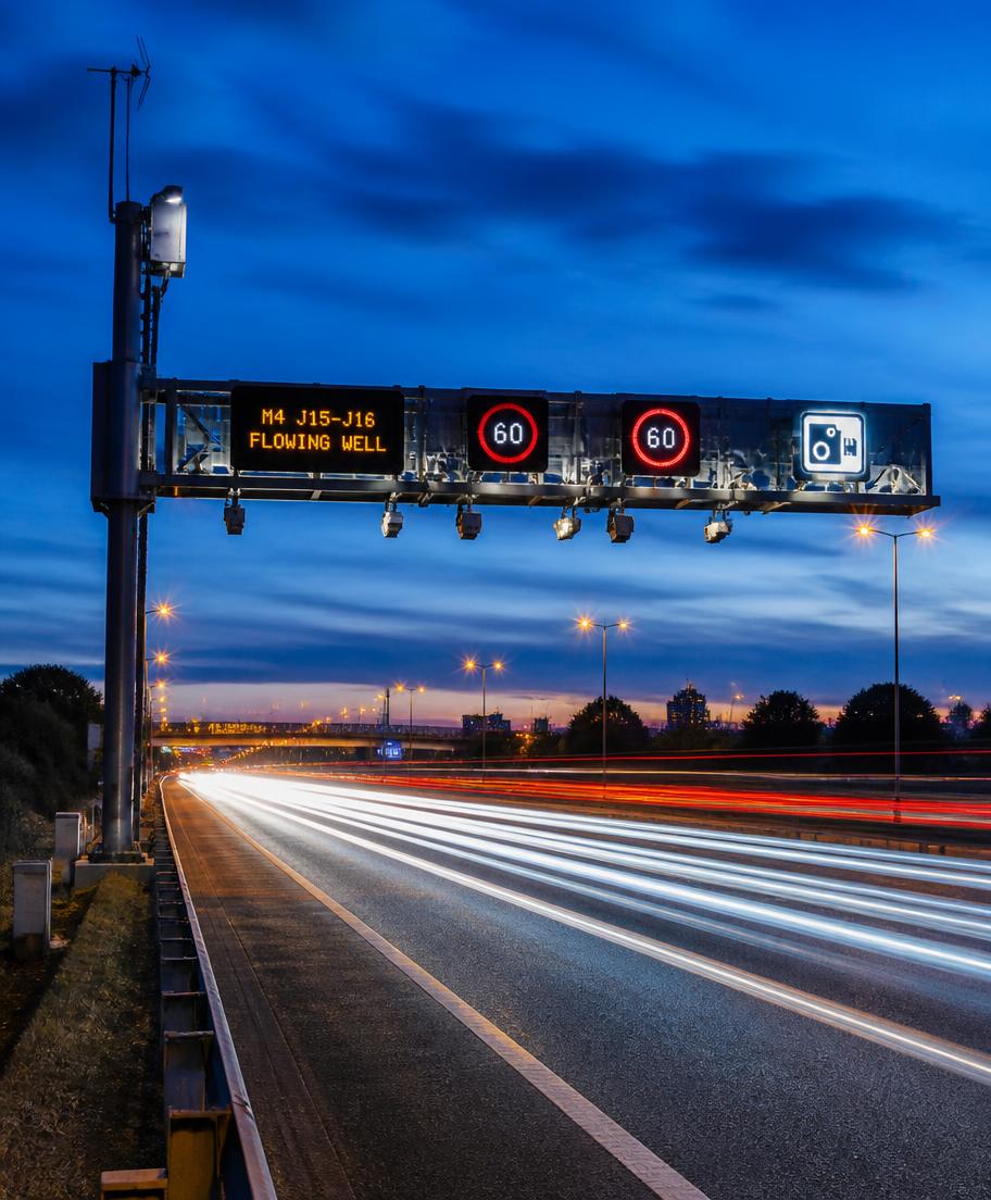 Highway gantry with smart sensors at dusk
